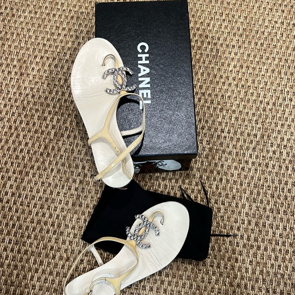 CHANEL silver CC cream sandals flats with buckles.